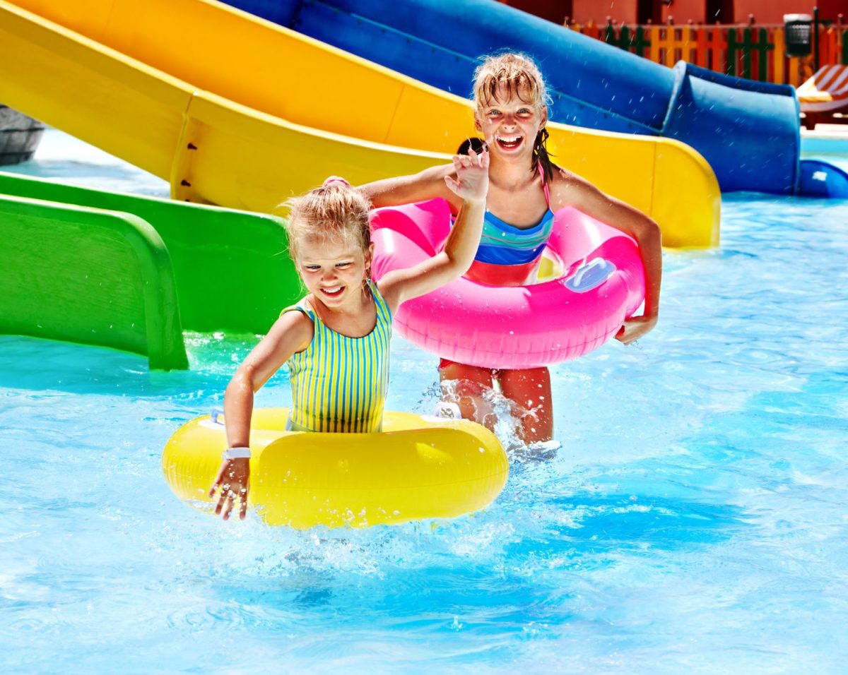 Two children in tubes from a waterslide.